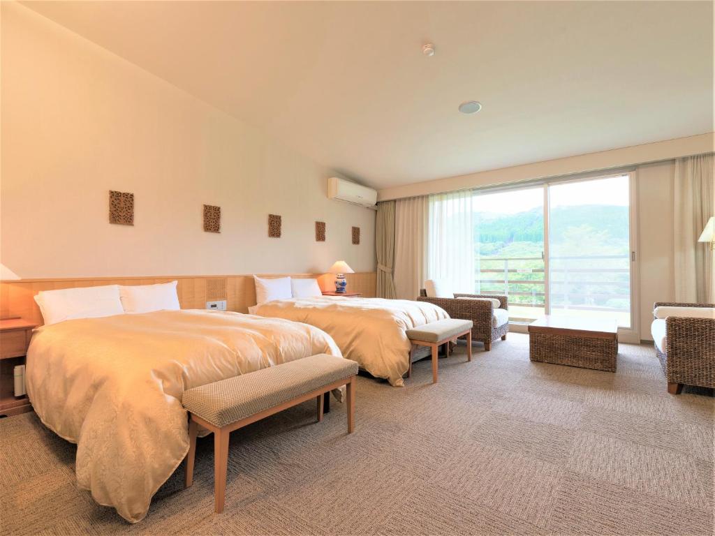 Postel nebo postele na pokoji v ubytování Mineyama Kogen Hotel Relaxia