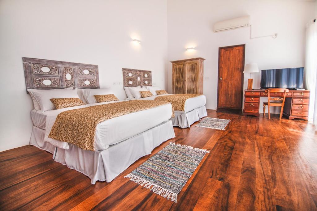 a hotel room with two beds and a television at Kandy Casa by Regus in Kandy