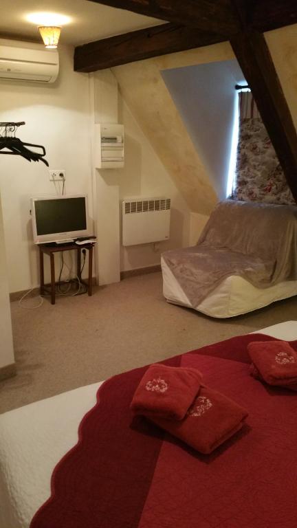 Postel nebo postele na pokoji v ubytování Chambres touristiques La Cour Des Hôtes