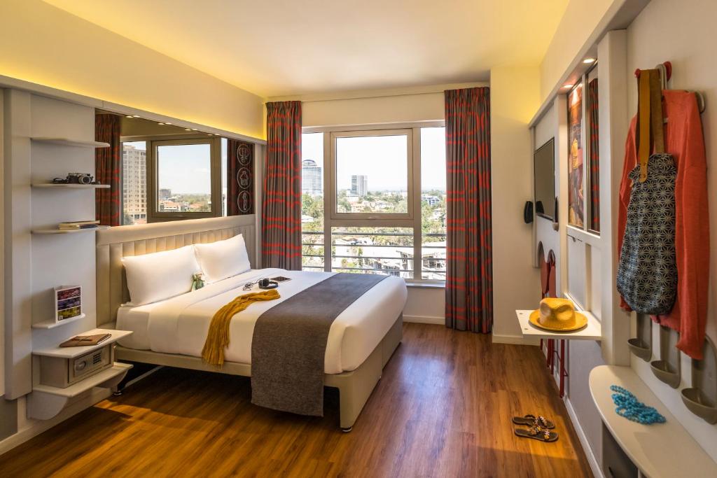 A bed or beds in a room at ibis Styles - Nairobi, Westlands