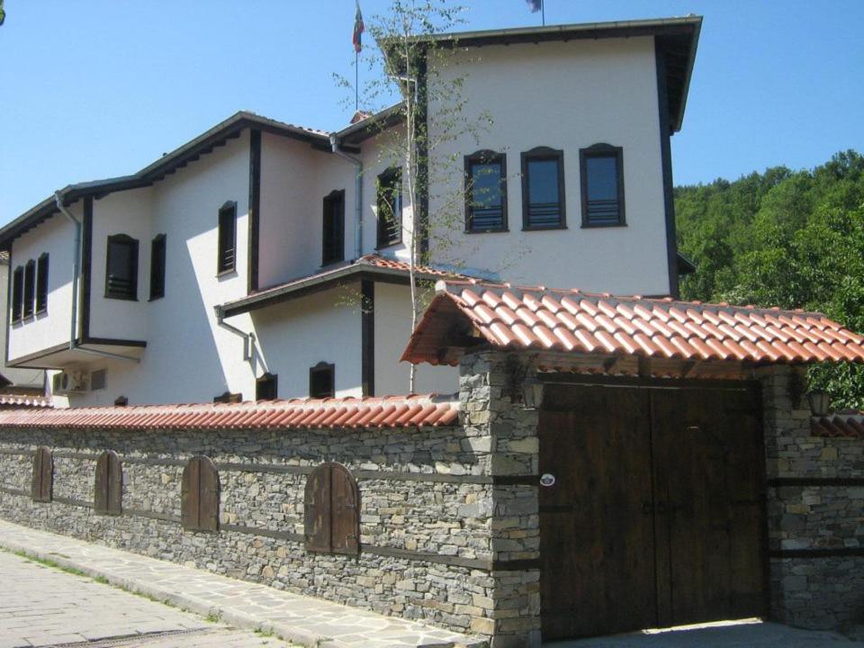 a house with a stone wall and a garage at комплекс ВОДОПАДА in Plovdiv