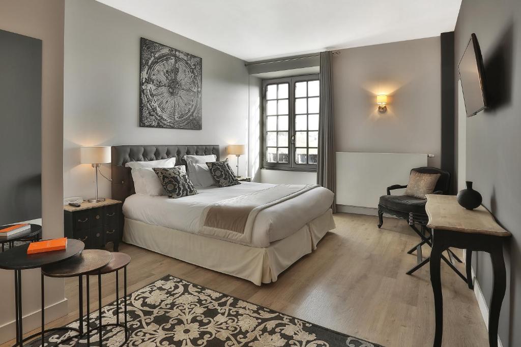 Postelja oz. postelje v sobi nastanitve Hôtel Joyet de Maubec