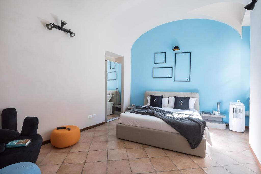 ein Schlafzimmer mit einem Bett in einem blauen Zimmer in der Unterkunft A World Aparts - 40 Sforza in Rom