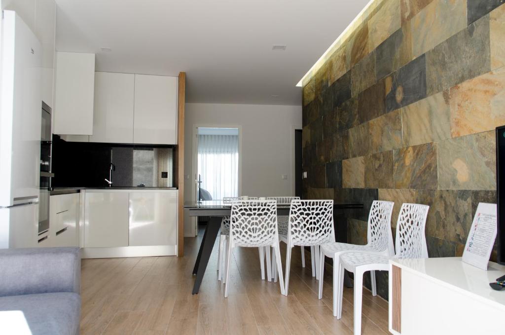 a kitchen and dining room with a table and chairs at Antónia's house in Ponte de Lima