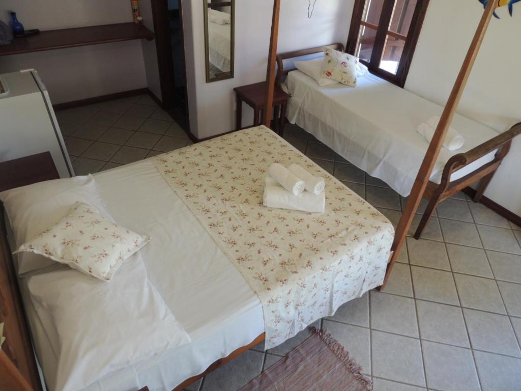 Cama ou camas em um quarto em Recanto da Praia