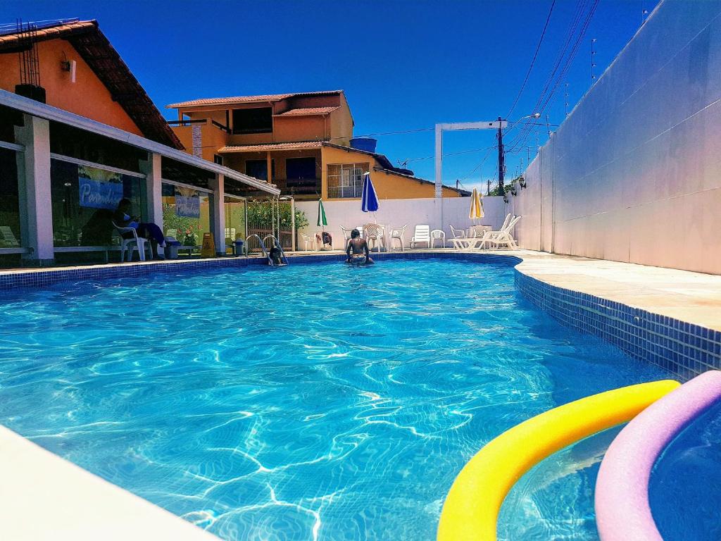 a swimming pool with blue water in a house at Pousada Paradise in Alcobaça