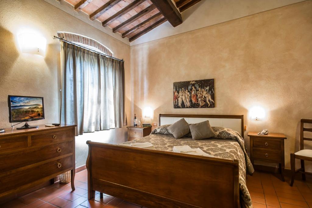 a bedroom with a bed and a dresser and a window at Antica Pieve B&B in Tavarnelle Val di Pesa