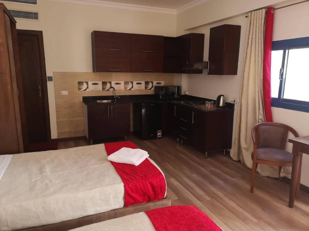 a hotel room with a bed and a kitchen at Cordoba Suites in Hurghada