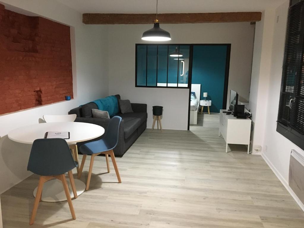 a living room with a couch and a table at Lombard in Toulouse