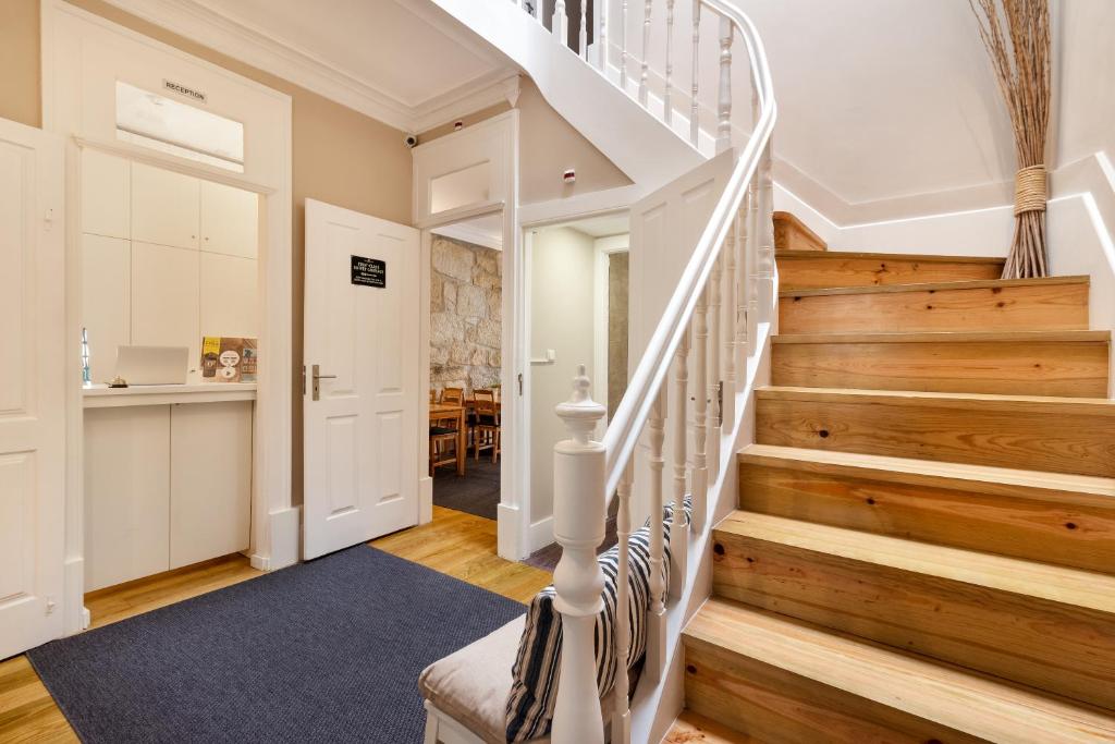 a staircase in a home with wooden floors at Fishtail Sea House in Matosinhos