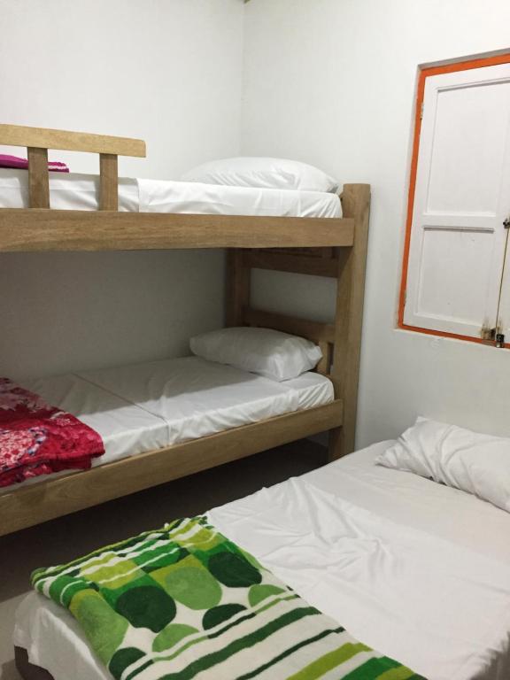 Postel nebo postele na pokoji v ubytování casa hostal las palmeras