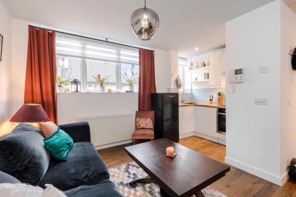 a living room with a couch and a table at The Nook Tower Bridge in London