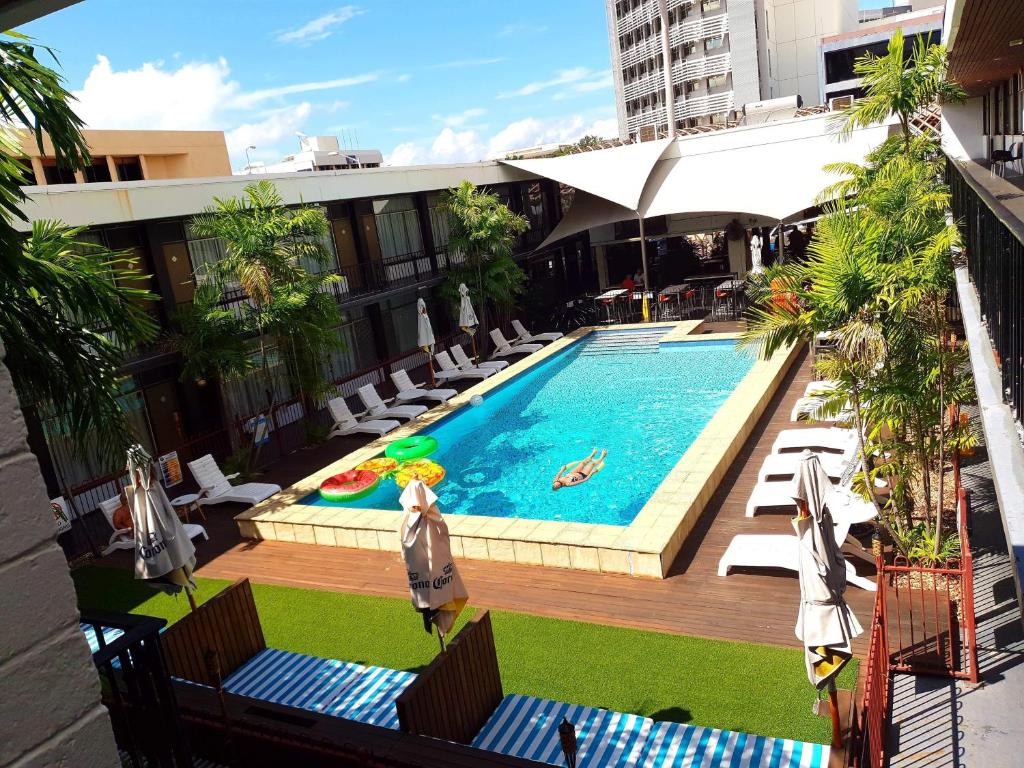 a swimming pool with a pool table and chairs at The Cavenagh in Darwin