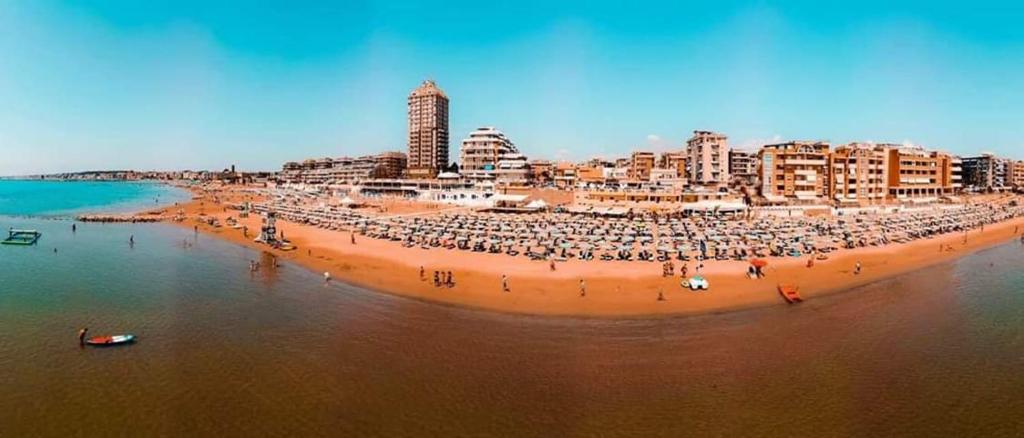 una playa con una gran multitud de personas en ella en Hotel Scacciapensieri en Nettuno