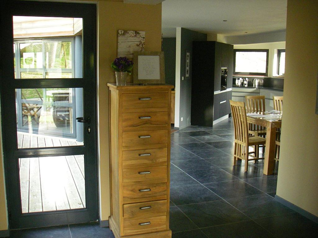 a kitchen with a dresser and a dining room with a table at VILLA KB&#39;HOME in Le Touquet-Paris-Plage