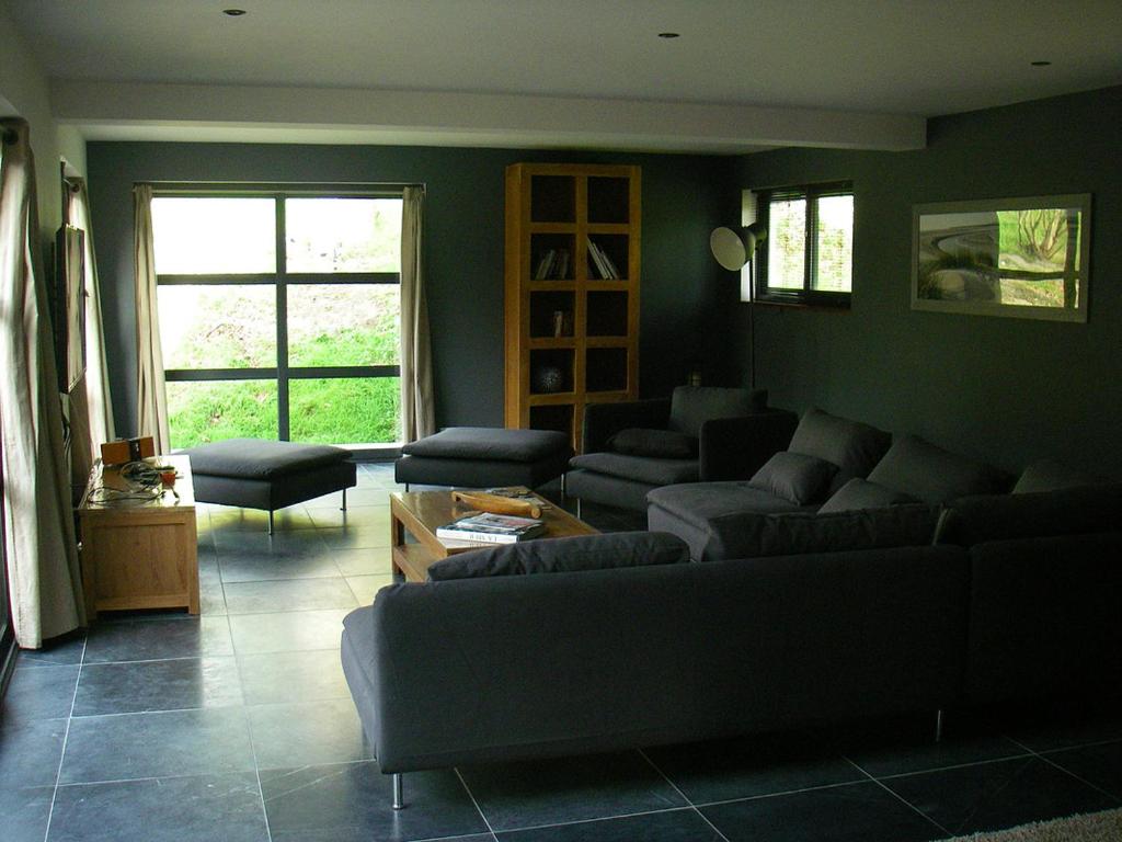 a living room with a couch and a table at VILLA KB&#39;HOME in Le Touquet-Paris-Plage