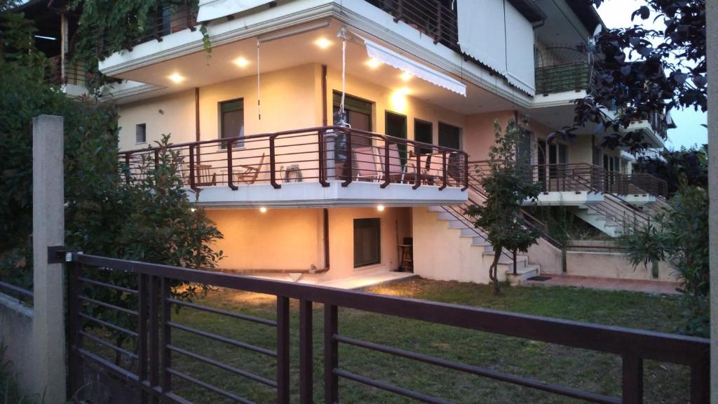 a house with a fence in front of it at Garden maisonnette 2-bedrooms sleeps 6 adults 200m from sandy beach in Asprovalta