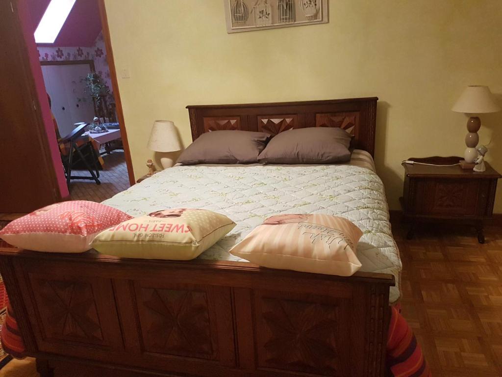 a bedroom with a bed with pillows on it at Horizon Aubrac Laguiole in Laguiole