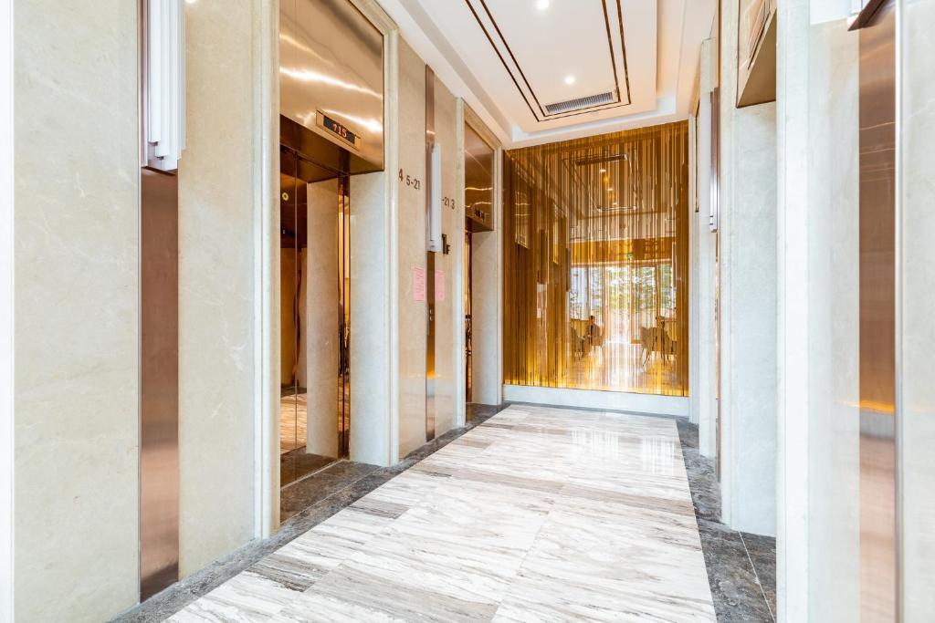 an empty hallway of a building with a window at Livetour Hotel Zhujiang New Town Guangzhou in Guangzhou