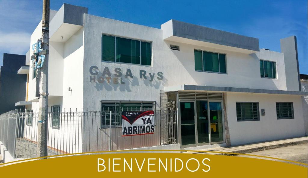 a white building with a sign on the side of it at Casa RyS Hotel in Ocotlán