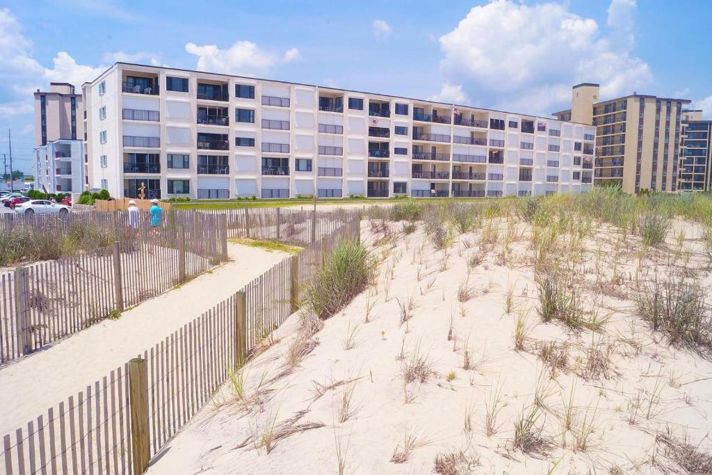 a sandy beach with a building in the background at Breakaway East 109 in Ocean City