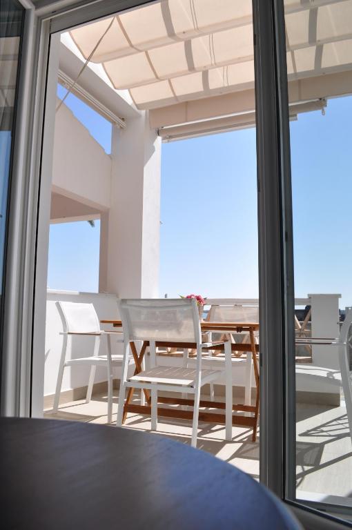 a room with a table and chairs on a balcony at Apartamentos en Paseo Maritimo in El Rompido