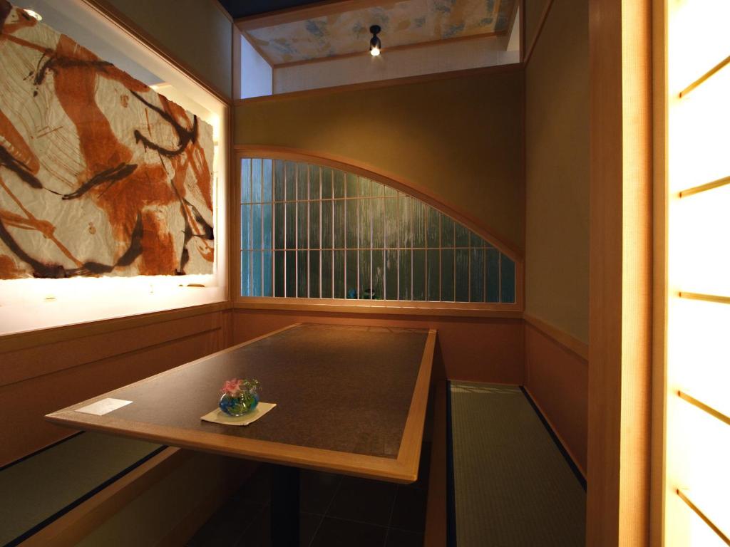 a small table in a room with a window at Inatori Tokai Hotel Yuen in Higashiizu