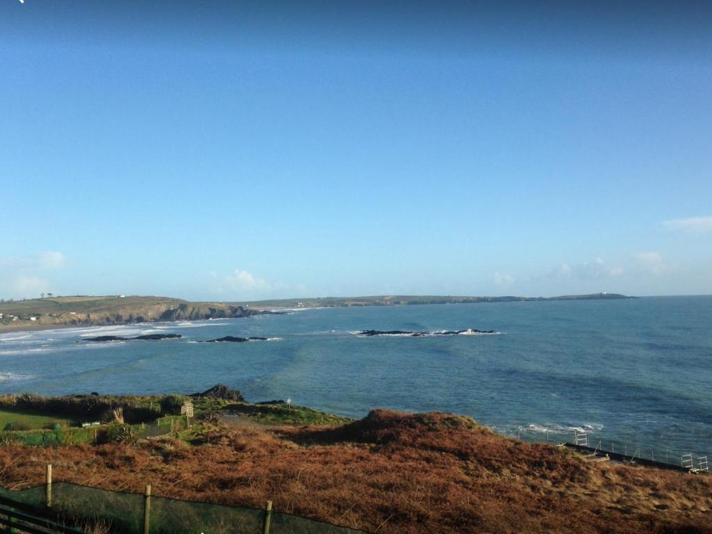 a view of the ocean with a boat in the water at Church Street Cottage in Rosscarbery