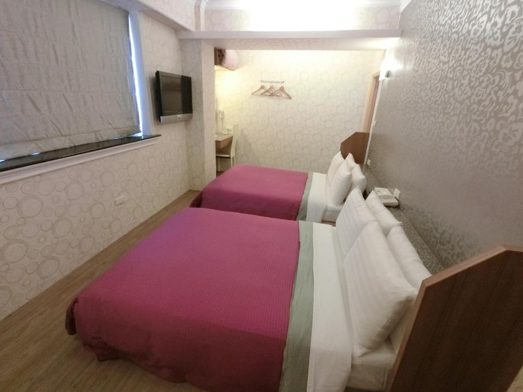 Postel nebo postele na pokoji v ubytování Nice Hotel