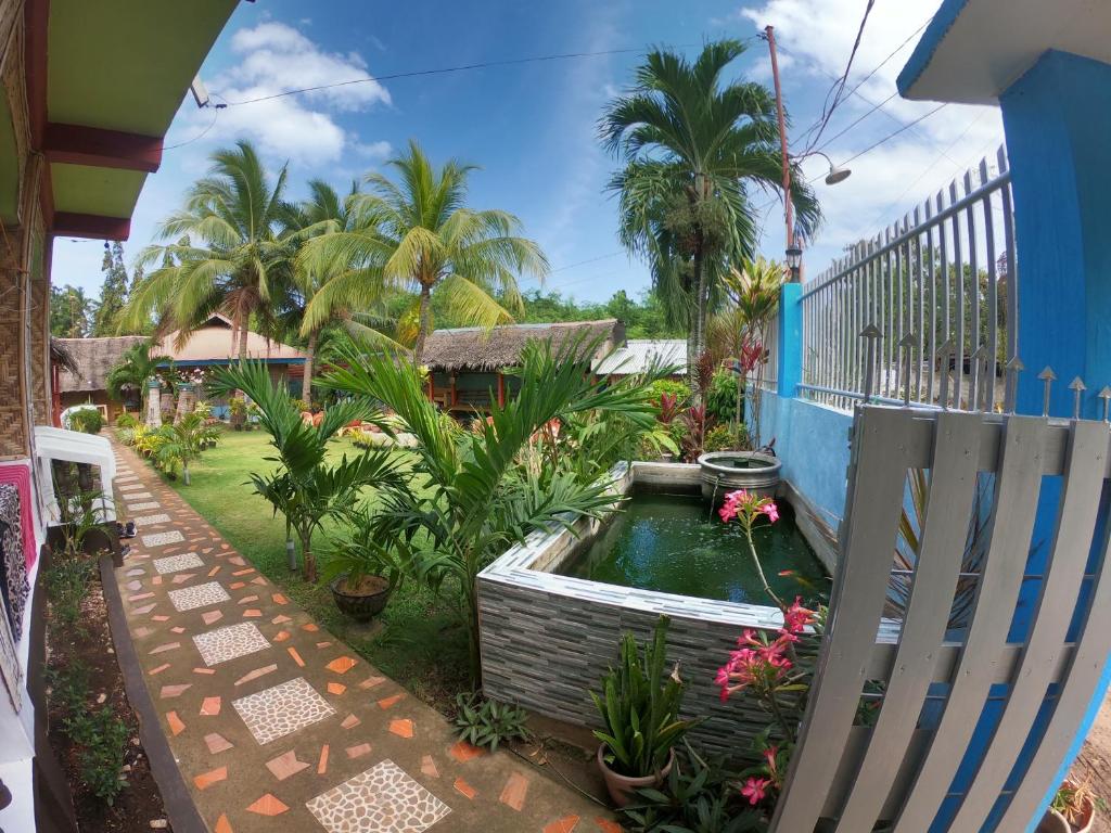 a garden with a pond in the middle of a yard at Bohol Sea Breeze Cottages and Resort in Panglao