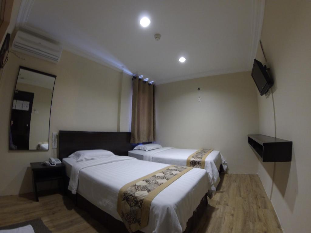 Postel nebo postele na pokoji v ubytování Hotel Kinabalu