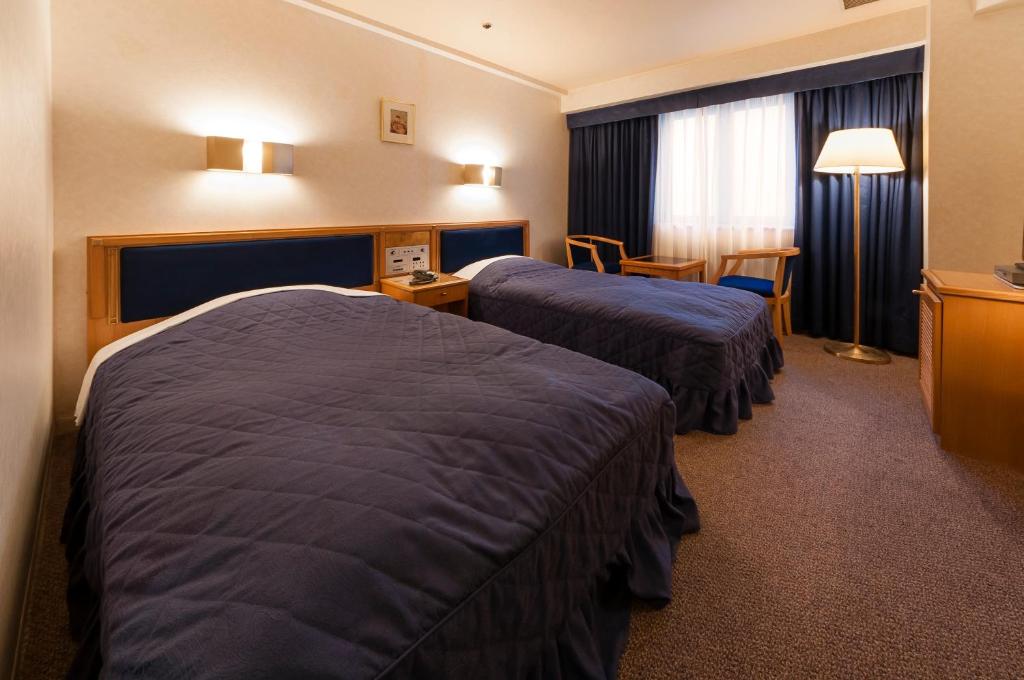 Postel nebo postele na pokoji v ubytování Hotel Siena