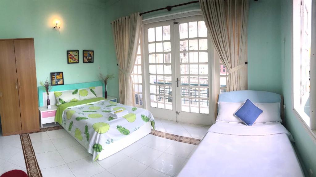 a bedroom with a bed and two windows at City Pass Da Lat in Da Lat