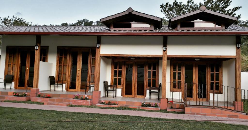 a small house with wooden doors and windows at PANAMA CAMPING PARK in Bajo Boquete