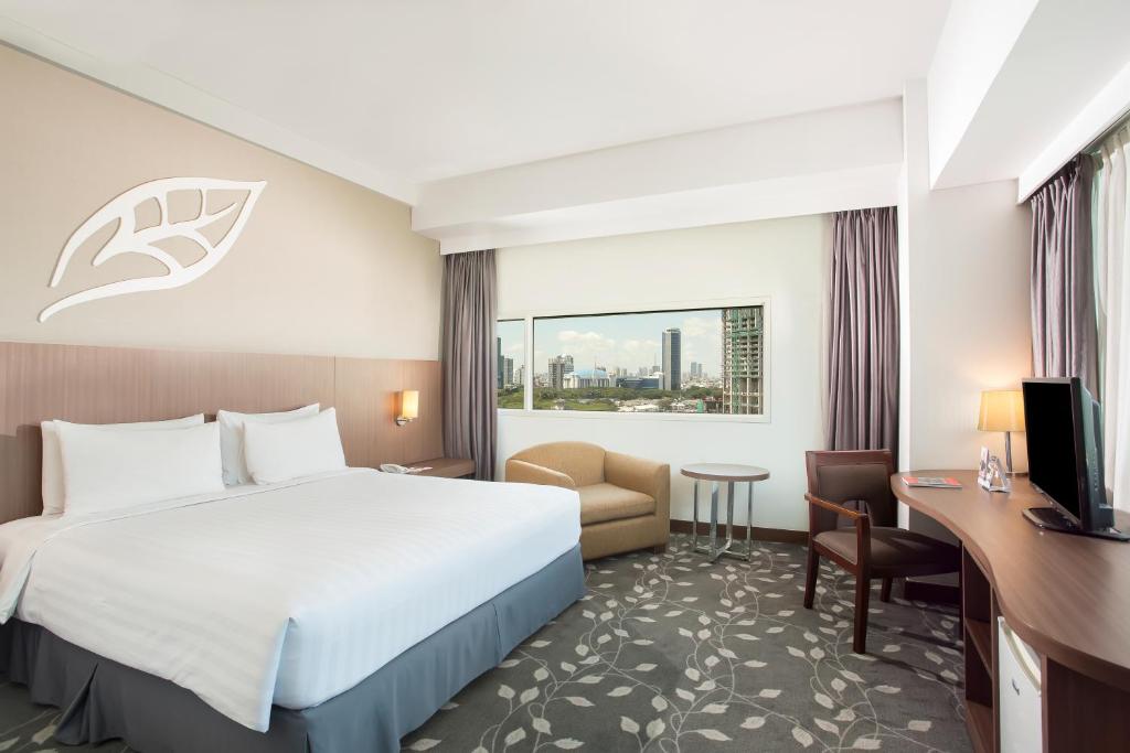 Postel nebo postele na pokoji v ubytování Swiss-Belinn Kemayoran
