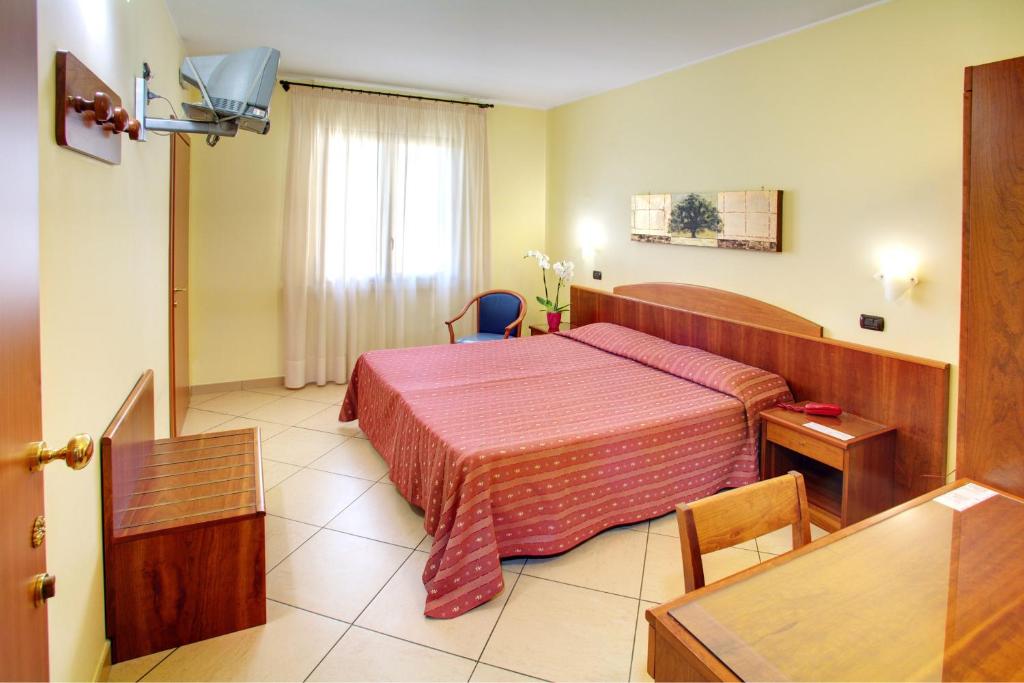 Postel nebo postele na pokoji v ubytování Lo Scacciapensieri Hotel & Restaurant