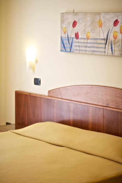 Postel nebo postele na pokoji v ubytování Lo Scacciapensieri Hotel & Restaurant