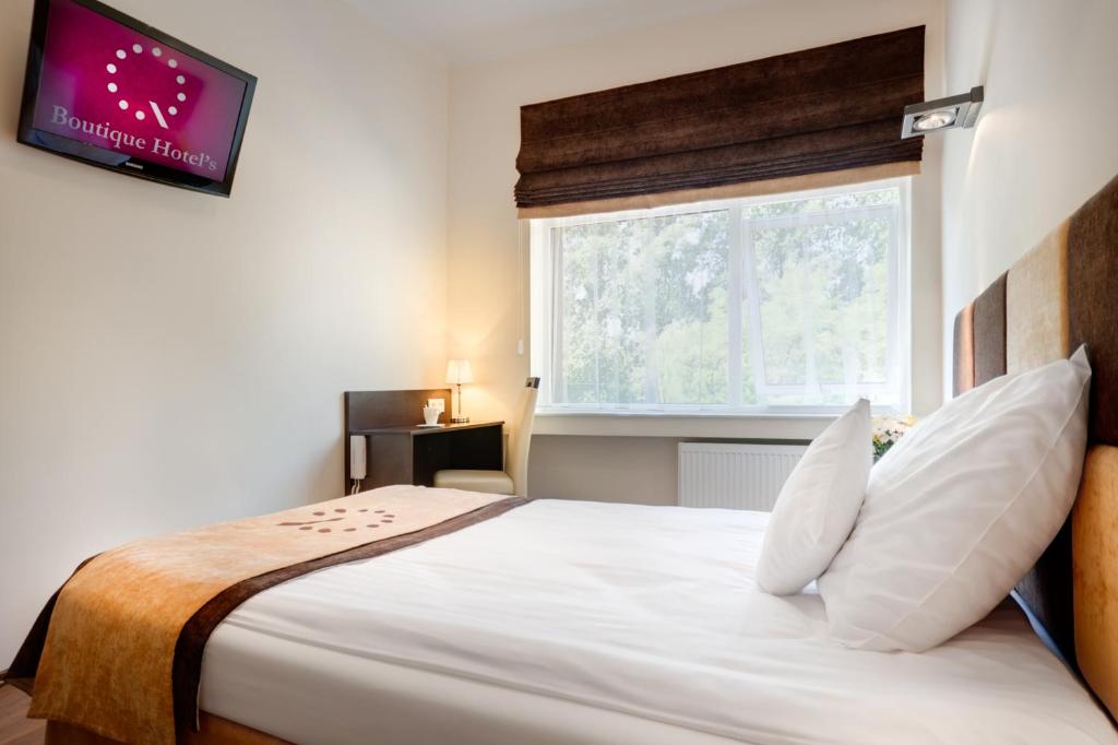 Postel nebo postele na pokoji v ubytování Boutique Hotel's Sosnowiec