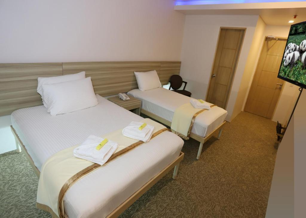 Postel nebo postele na pokoji v ubytování 1010 Hotel