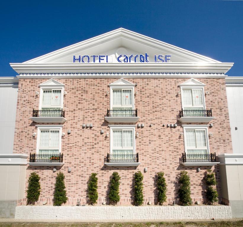 a red brick building with a hotel car rental use at Carrot ISE (Adult Only) in Ise