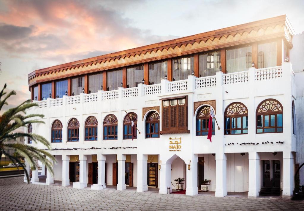 a white building with a lot of windows at Souq Waqif Boutique Hotels - Tivoli in Doha