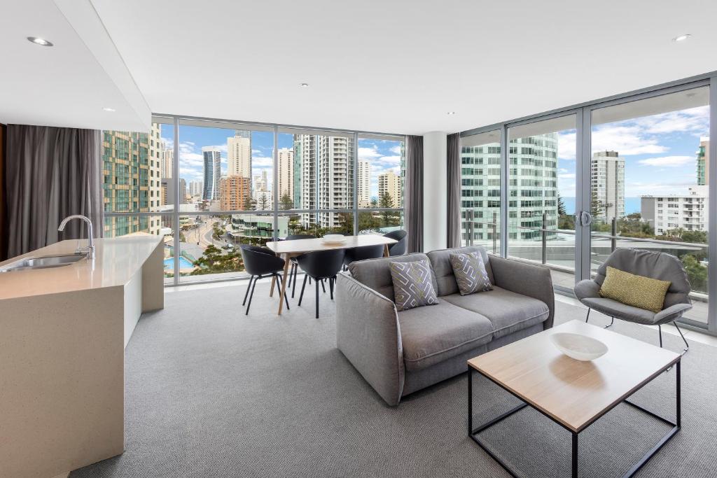 
a living room filled with furniture and a large window at Wyndham Resort Surfers Paradise in Gold Coast
