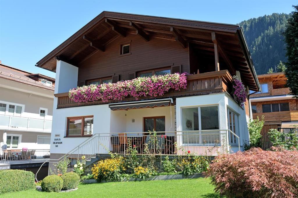 a house with flowers on the balcony of it at Haus Dejakom Mayrhofen in Mayrhofen