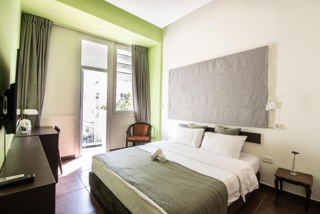 Postel nebo postele na pokoji v ubytování 27Montefiore - Urban ApartHotel TLV