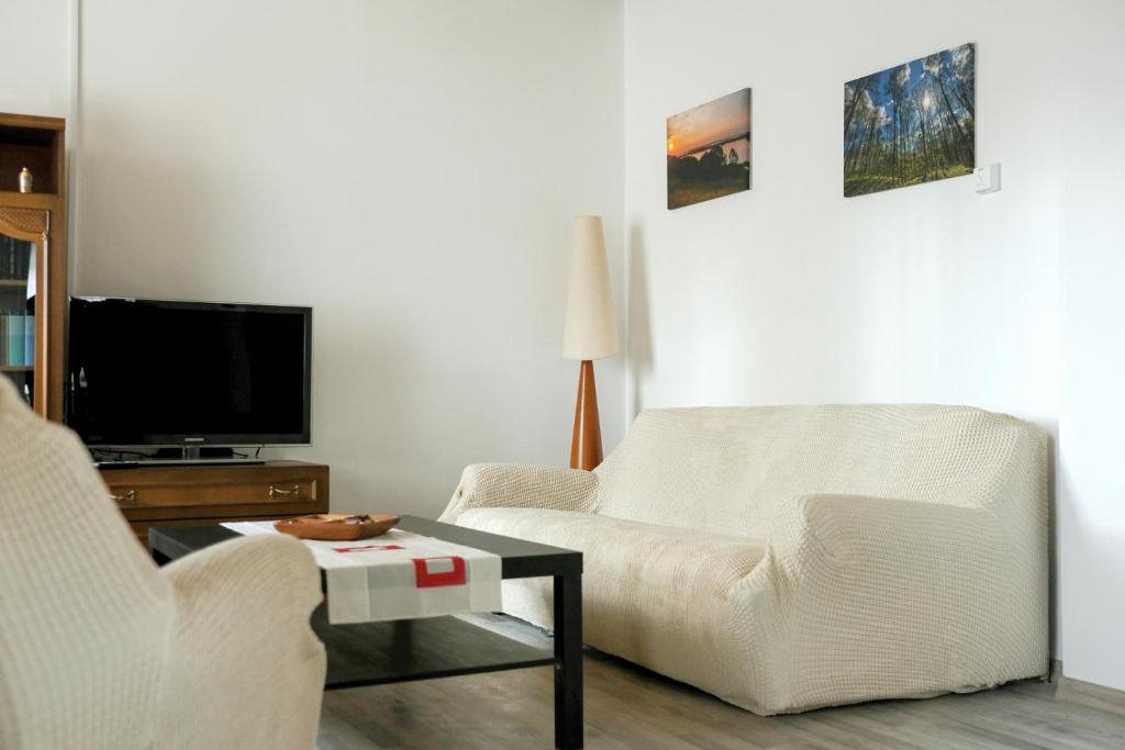 a living room with two chairs and a tv at House of Tea in Bjelovar