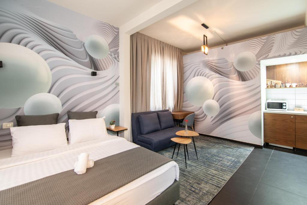 a hotel room with a bed and a chair at 27Montefiore - Urban ApartHotel TLV in Tel Aviv
