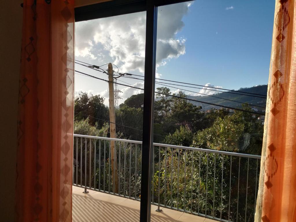 a window with a view of the view from a house at Casa Mao-Cheia in Arco da Calheta