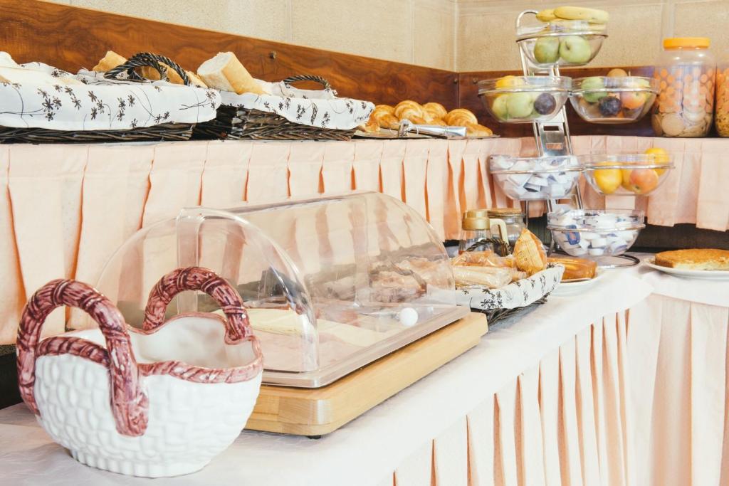 a buffet with bread and pastries on a table at Hotel Alameda in Zarautz