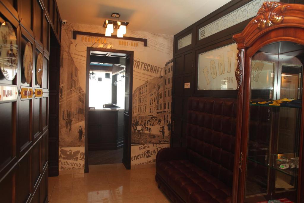 a hallway with a door in a room with posters on the walls at Fontush Boutique Hotel in Ivano-Frankivsk
