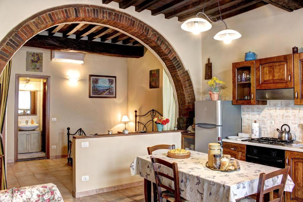 a kitchen with an archway and a table in a room at Casa Billi in Figline Valdarno